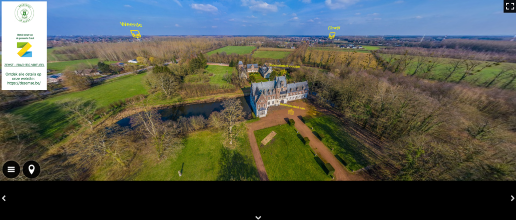 Een kasteel in het groen met blauwe lucht, in vogelvlucht