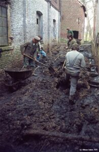 Mensen aan het werk met schop en kruiwagen